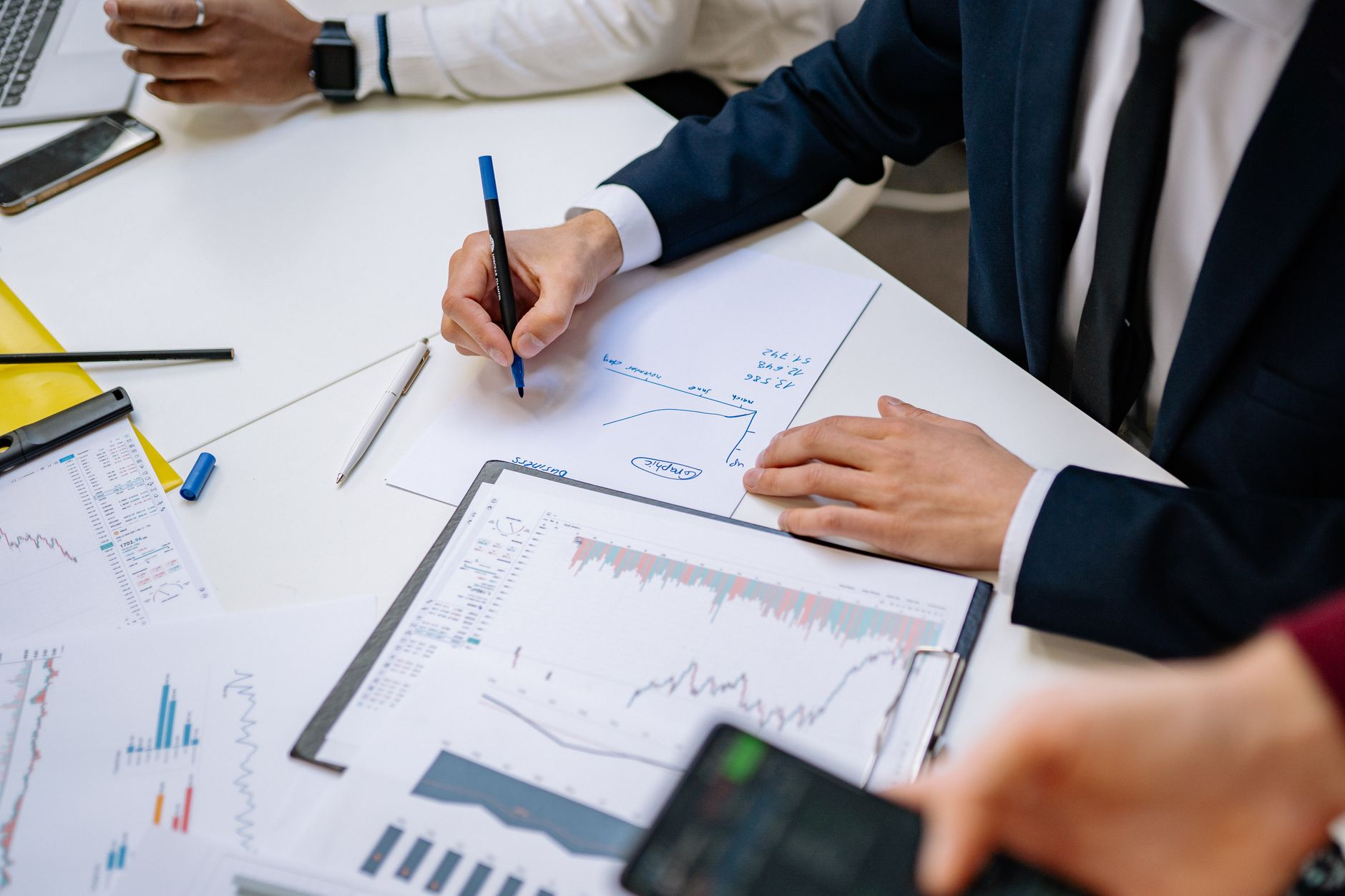 Professionals analyzing financial charts in a corporate setting. — From Childhood Aspirations to Measurable Global Change: Th