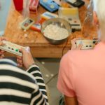 Two teenagers play video games together with snacks, creating a fun indoor atmosphere. — How To Unlock All The Fortnite Hacks