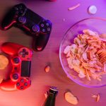Overhead view of game controllers and snacks on a table, perfect for a gaming night setup. — Information in Contact