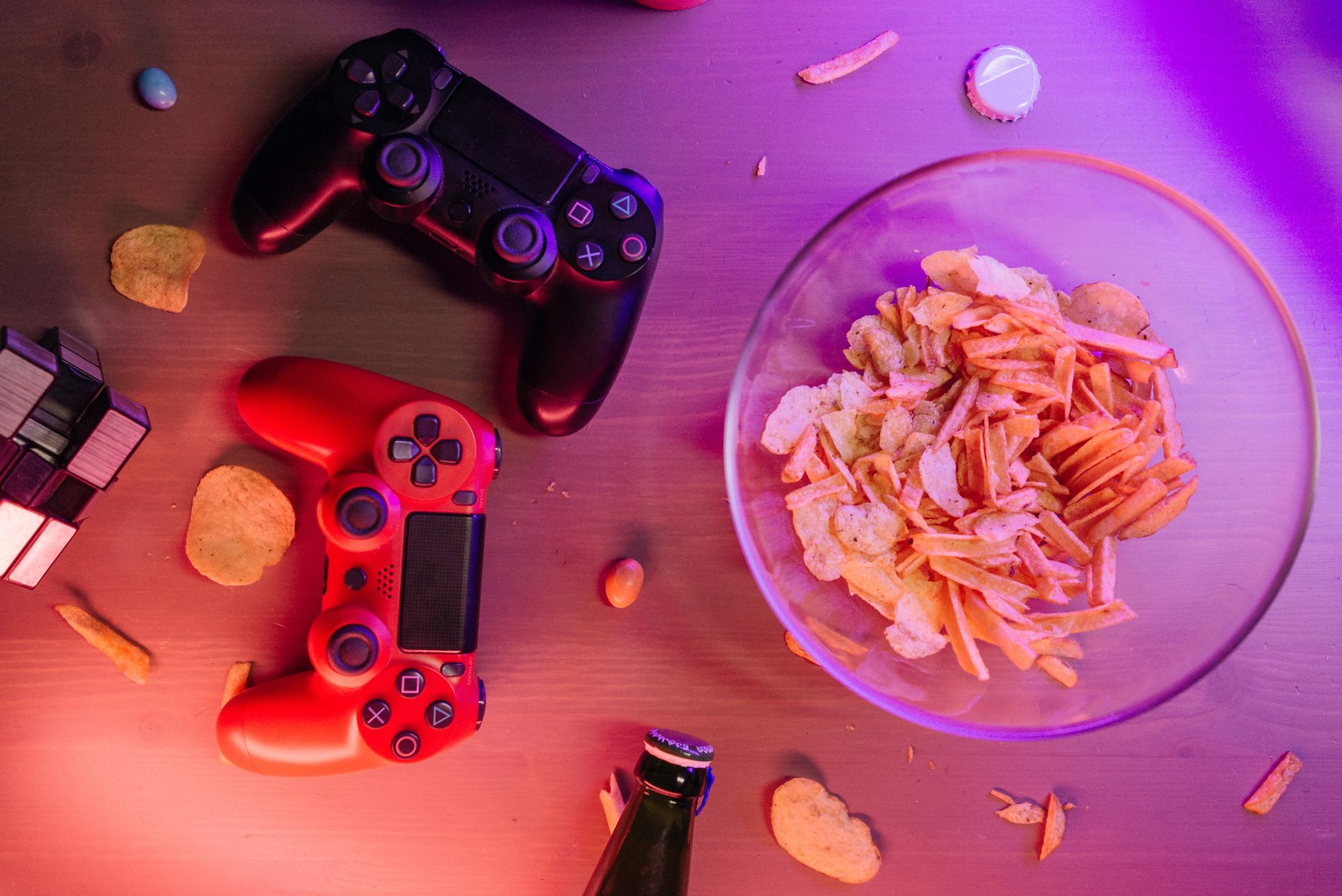 Overhead view of game controllers and snacks on a table, perfect for a gaming night setup. — Information in Contact