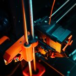 A colorful close-up of a 3D printer operating, showcasing mechanical precision and technology. — On-line Data