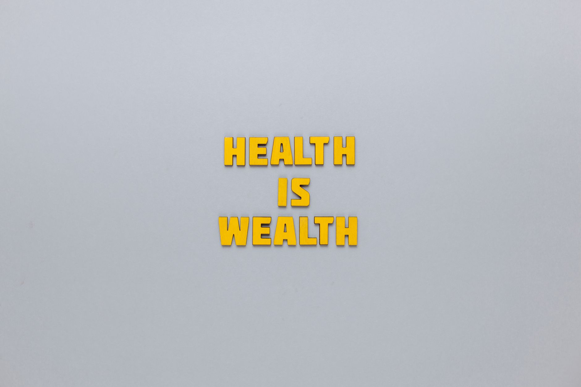 Inspirational phrase 'Health is Wealth' in bold yellow letters on a neutral gray background. — Step-by-Step Process for Order