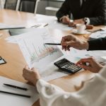 Professionals reviewing financial graphs and charts during a meeting. — Luxurious Garden Room with Unobstructed Views