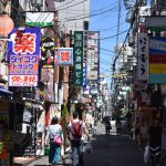 Bustling urban street in Osaka with colorful advertisements and pedestrians in daylight. — Stylish and Durable Windows for Ro