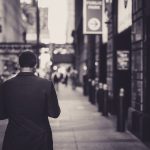 Man in a suit walking down a city street in a lonely, urban setting. — The Comprehensive Guide to Aetna Medicare Advantage 20