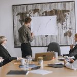 Group of business professionals discussing strategies with growth chart in conference room. — Understanding the Benefits of T