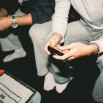 Two adults enjoying a video game session together, focused on controllers. — What are the prerequisites for participating in