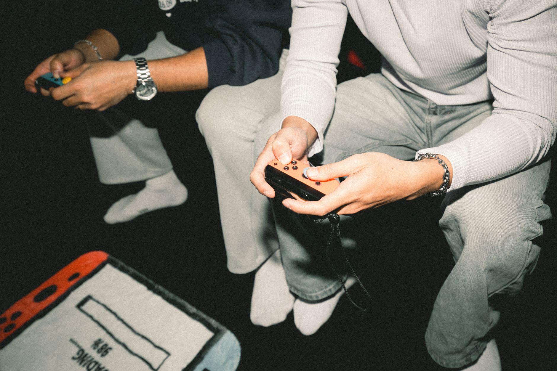 Two adults enjoying a video game session together, focused on controllers. — What are the prerequisites for participating in